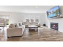 Bright living room with hardwood floors, a fireplace, large windows, and cozy sectional seating at 3737 Planck St, Danville, IN 46122
