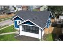 A high-angle view reveals a charming blue home with a well maintained dark roof at 3967 N Park Ave, Indianapolis, IN 46205