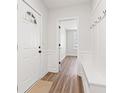 Bright entryway boasts new laminate flooring, wainscoting, coat hooks, and a convenient built-in bench at 401 N Swope St, Greenfield, IN 46140