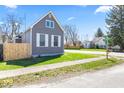 Street view of home featuring classic architecture, a well-maintained yard, and a serene neighborhood setting at 401 N Swope St, Greenfield, IN 46140