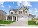 Charming two-story home with a well-manicured lawn, large windows and a two car garage on a beautiful sunny day at 4152 Dutton Dr, Bargersville, IN 46106