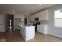 Bright kitchen with white cabinets, an island with a sink, and stainless steel appliances at 4152 Dutton Dr, Bargersville, IN 46106