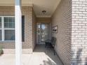 Inviting covered entryway with neutral brick, ideal for greeting guests and enjoying a quiet moment at 4631 Belair Cir, Plainfield, IN 46168