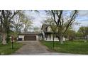 Charming two-story home with attached garage, set back on a lot with mature trees and a long driveway at 543 Schooley Dr, Greenwood, IN 46142