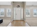 Bright and airy foyer with tile flooring and views into adjacent rooms through large windows at 621 Fireside Dr, Greenwood, IN 46143