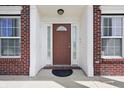 Close-up of the front door, flanked by windows and adorned with elegant molding at 621 Fireside Dr, Greenwood, IN 46143