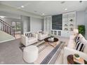 Cozy living room with white furniture, modern built-ins, and soft carpet for a welcoming atmosphere at 6234 N Woods Edge Dr, McCordsville, IN 46055