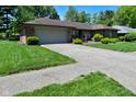 Attractive brick ranch-style home with a neat front lawn and a spacious driveway at 6318 Dahlia Dr, Indianapolis, IN 46217