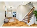 Inviting foyer with wood floors, wainscoting, staircase and ample natural light at 7158 Sugar Maple Ln, Brownsburg, IN 46112