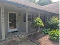 Inviting front porch with brick accents, columns, and a well-maintained garden at 8017 Dogwood Ct, Plainfield, IN 46168
