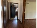 Hallway view showcases dark wood trim and the kitchen in the distance at 8122 Tanager Ct, Indianapolis, IN 46256