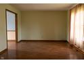 Bright living room with hardwood floors and a large window for natural light at 8122 Tanager Ct, Indianapolis, IN 46256
