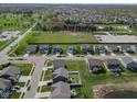 Wide aerial shot reveals a neatly arranged suburban community with modern homes, green spaces, and organized street layouts at 8442 Averly Park Dr, Indianapolis, IN 46237