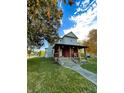 Charming two-story home with a welcoming front porch and well-maintained lawn, perfect for enjoying outdoor living at 905 W 3Rd St, Anderson, IN 46016