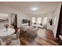 Bright living room features stylish furniture and sleek hardwood floors with a dining area, creating a comfortable space at 905 W 3Rd St, Anderson, IN 46016