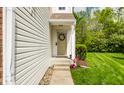 Side entrance with a decorative wreath and landscaped walkway to the front door at 9338 Eden Woods Ct, Indianapolis, IN 46260