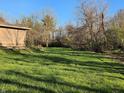 A spacious backyard featuring lush green grass and various trees for a serene outdoor setting at 935 Fry Rd, Greenwood, IN 46142
