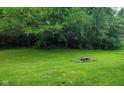 View of backyard with abundant trees offering great privacy and a well-maintained lawn at 935 Fry Rd, Greenwood, IN 46142