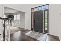 Inviting foyer with hardwood floors, stylish rug, and view into the living room at 945 Baywood Ct, Columbus, IN 47201