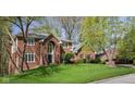 A beautiful brick home is shown with well kept lawn and professional landscaping on a lush lot at 9838 Gulfstream Ct, Fishers, IN 46037