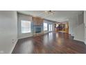 Open-concept living room boasts hardwood floors, a brick fireplace, and ample natural light at 10689 Brooks St, Indianapolis, IN 46234