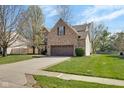 Charming brick home with a well-maintained lawn and mature trees, creating an inviting curb appeal at 11347 Whitewater Way, Fishers, IN 46037