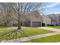 Lovely brick home with a spacious front yard, showcasing its classic architecture and neighborhood setting at 11347 Whitewater Way, Fishers, IN 46037
