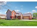 Beautiful brick home with well-kept lawn, featuring an attached garage and classic architectural details at 12088 Everwood Cir, Noblesville, IN 46060