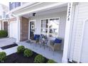 Inviting front porch with chairs and table, perfect for relaxing outdoors at 12678 Brewton St, Fishers, IN 46038