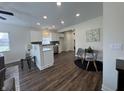 Bright kitchen with white cabinets, stainless appliances, an island and wood-look floors at 128 W Walnut St, Lebanon, IN 46052