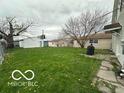 Spacious backyard with green grass and detached garage offers potential for outdoor enjoyment at 137 S 2Nd Ave, Beech Grove, IN 46107