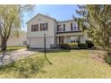 Charming two-story home featuring red shutters, a two-car garage, and well-maintained landscaping at 14117 Princewood Dr, Fishers, IN 46037
