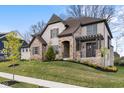 Attractive two-story home featuring a stone and brick facade, complemented by a green lawn and landscaping at 14872 Autumn View Way, Fishers, IN 46037