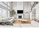 Bright and spacious living room with a fireplace, large windows, and stylish modern decor at 14872 Autumn View Way, Fishers, IN 46037