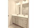 Bathroom with a double vanity, granite countertops, and well-lit mirrors at 5125 Gerhing Dr, Indianapolis, IN 46239