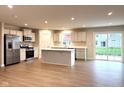 Open concept kitchen with an island, modern appliances, and abundant natural light at 5125 Gerhing Dr, Indianapolis, IN 46239