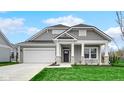 Beautiful home with a covered porch, gray siding, a well-manicured lawn, and a two-car garage at 16870 Imperial Ct, Fishers, IN 46040