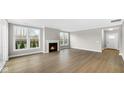 Bright living room with a fireplace, large windows, and wood flooring at 16870 Imperial Ct, Fishers, IN 46040