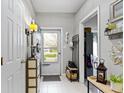 Bright foyer with tile flooring, coat rack, and neutral décor creating a welcoming entrance to the home at 17072 Newberry Ln, Westfield, IN 46074