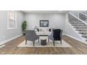 Open-concept living room featuring modern decor, a cozy seating area, and sleek hardwood floors at 2326 Guilford Ave, Indianapolis, IN 46205