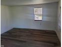 A cozy bedroom featuring sleek wood floors and a bright window at 2801 Brouse Ave, Indianapolis, IN 46218