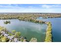 Expansive aerial view showcasing the lake and surrounding homes in a beautiful landscape at 3748 Bay Rd S Dr, Indianapolis, IN 46240
