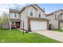 A well-maintained two-story home with a two-car garage, brick accents and a nicely landscaped front yard at 4417 Barharbor Ct, Indianapolis, IN 46268
