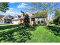 Two-story brick home featuring an attached two-car garage and well-manicured lawn at 4606 Sundance Trl, Indianapolis, IN 46239