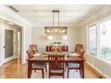 Formal dining room with hardwood floors, stylish chandelier, and elegant decor for Gathering gatherings at 5875 Annanhill Ct, Avon, IN 46123