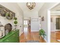 Welcoming entryway with hardwood floors, decorative accents, and a charming rustic chandelier overhead at 5875 Annanhill Ct, Avon, IN 46123