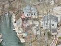 Aerial view of two lakeside homes with docks, decks and stairs surrounded by trees at 6141 Flamingo Dr, Nineveh, IN 46164