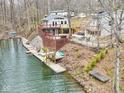 Lakeside homes feature multi-tiered decks, stairs and a boat dock for waterfront living at 6141 Flamingo Dr, Nineveh, IN 46164
