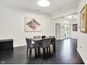 Modern dining room featuring a sleek table, stylish chairs, and chic black herringbone floors at 6430 Meridian Pkwy # Apt A, Indianapolis, IN 46220