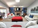 Cozy living room featuring a brick fireplace, built-in shelving, and comfortable seating at 6723 Balmoral Rd, Indianapolis, IN 46241